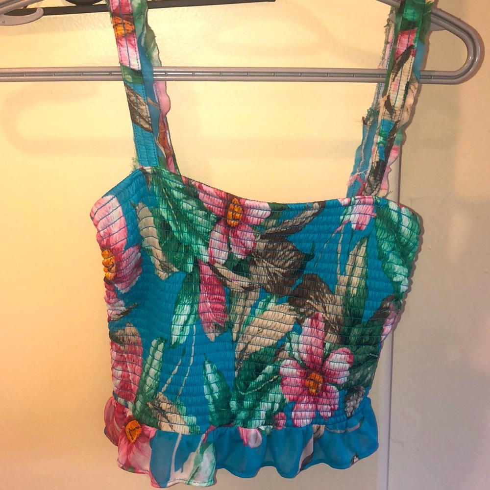 This beautiful fringe tank top has so many different flowers on it and is lovely
